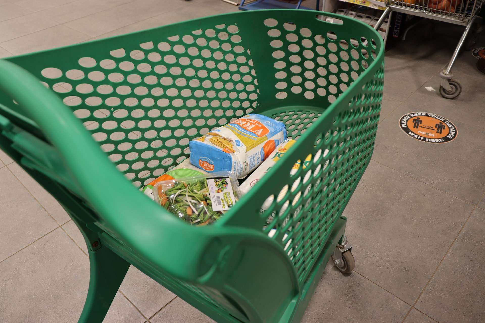 Supermarket shopping trolley and aisle